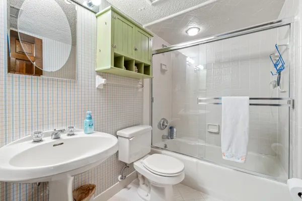 a bathroom with a sink toilet and shower