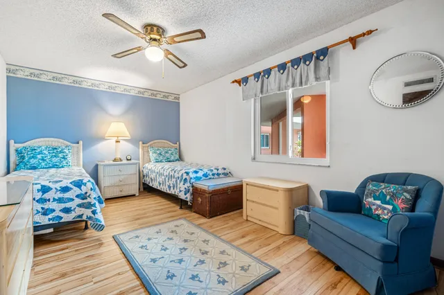 a bedroom with a bed window and a couch