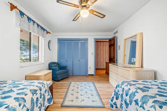 a bedroom with two beds and a window