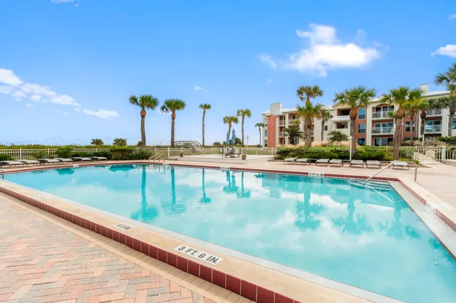 a view of an ocean with a building in the background