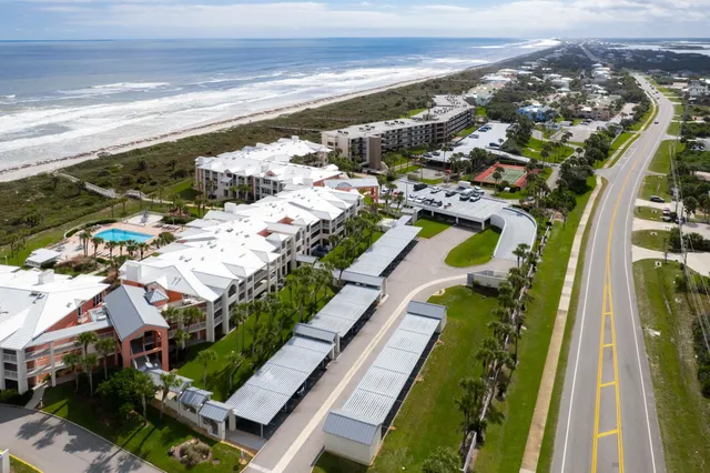 an aerial view of a house with a ocean view
