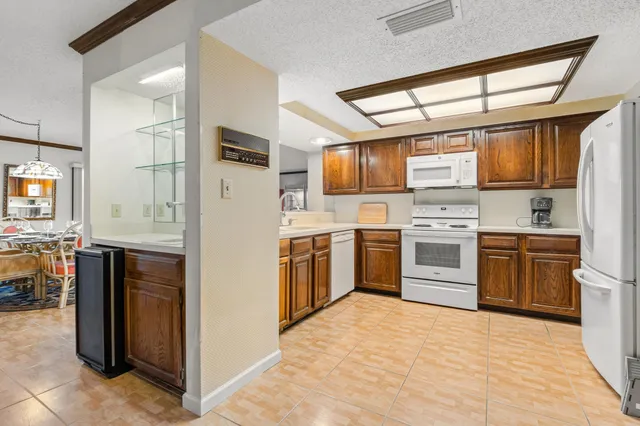 a kitchen with stainless steel appliances granite countertop a stove top oven and refrigerator