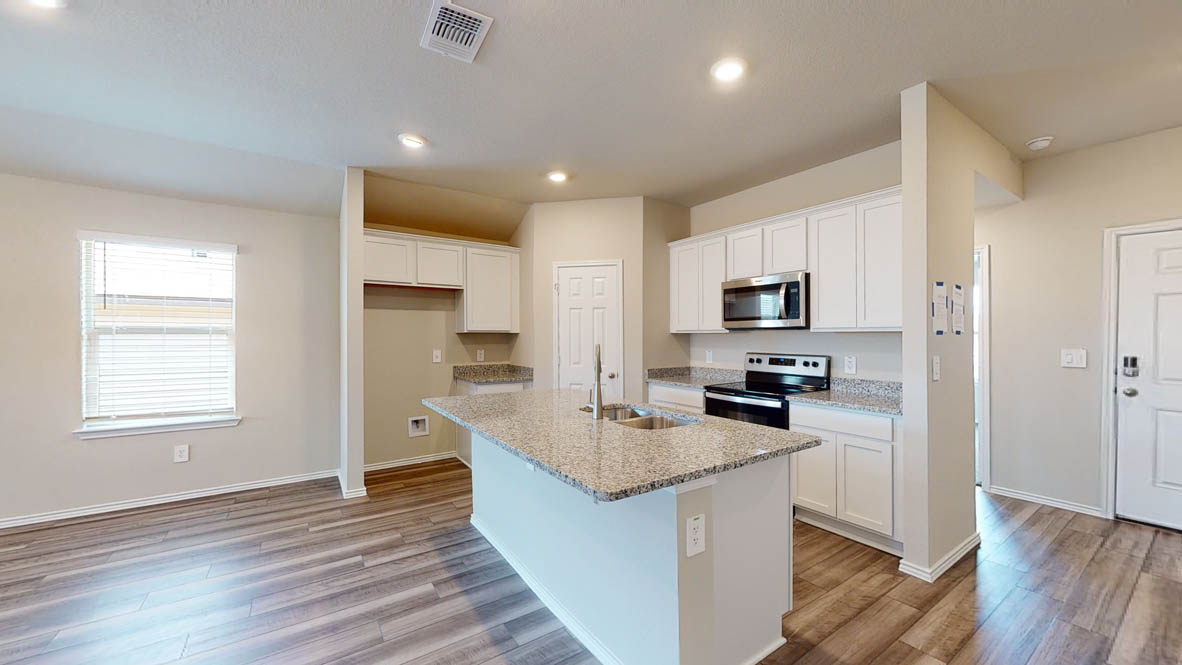 596 Hector Loop Georgetown, TX 78626 - Photo 3 of 14 Granite counters and stainless steel appliances outfit this functional kitchen, perfect for everyday living.