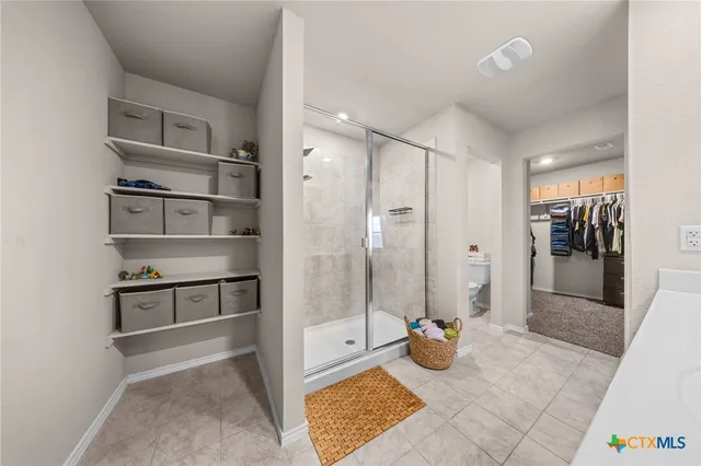 a view of an empty room and kitchen view