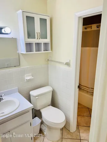 a white toilet sitting next to a bathroom sink