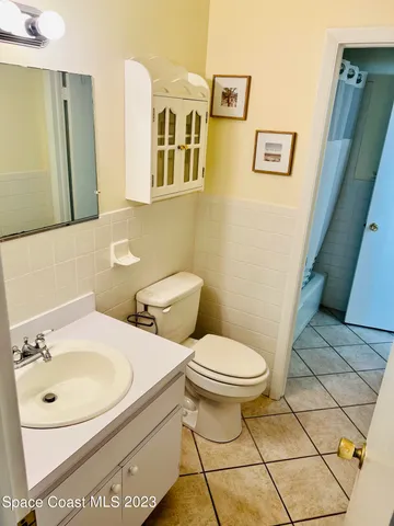 a bathroom with a sink toilet and mirror