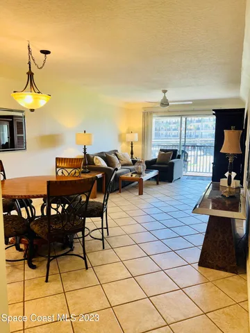 a living room with furniture a rug and a chandelier