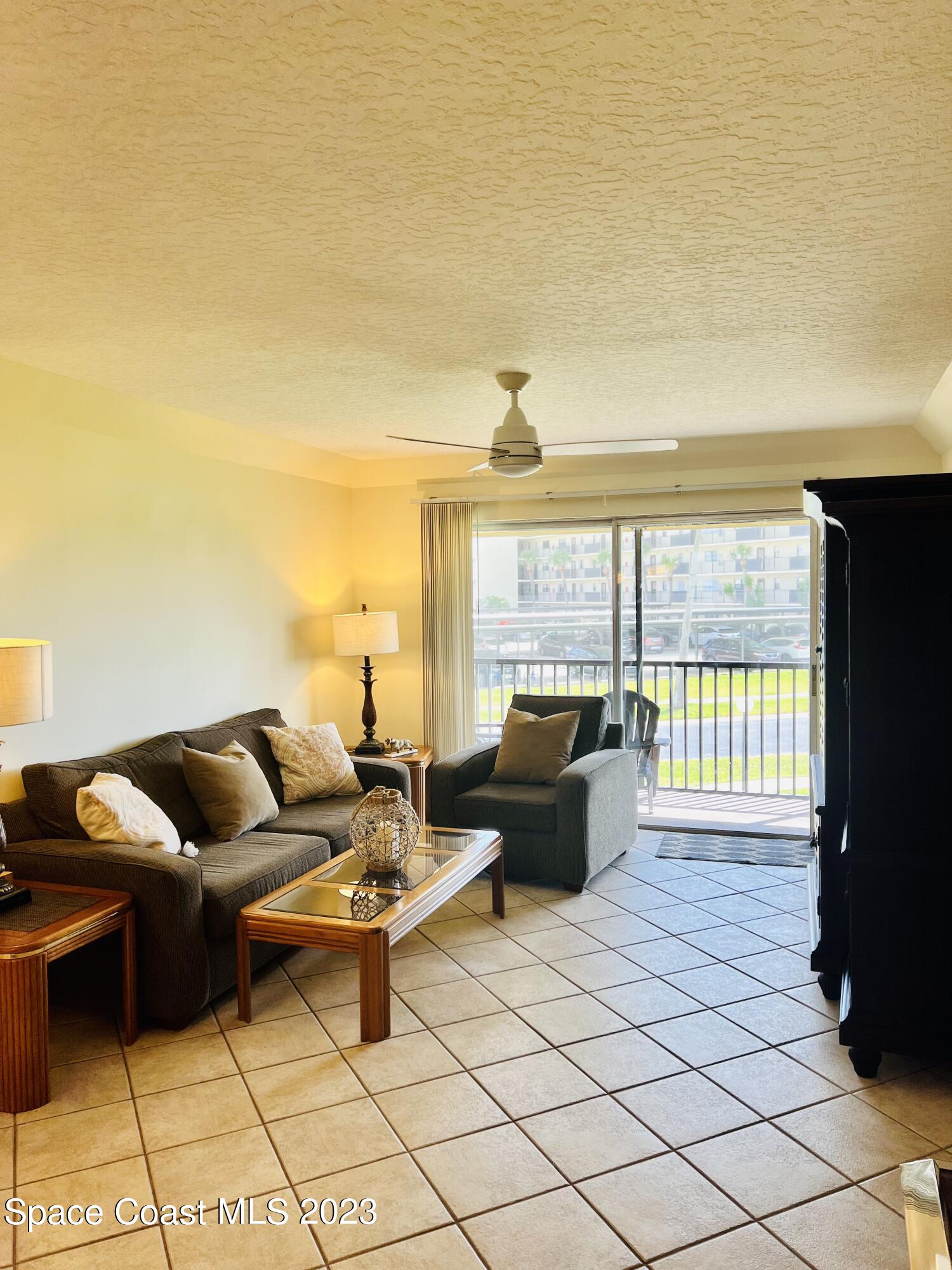 416 School Road, Unit 204 Indian Harbour Beach, FL 32937 - Photo 6 of 14 a living room with furniture and a flat screen tv