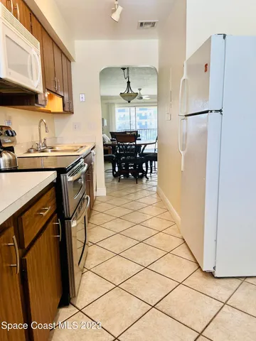 a kitchen with refrigerator and cabinets