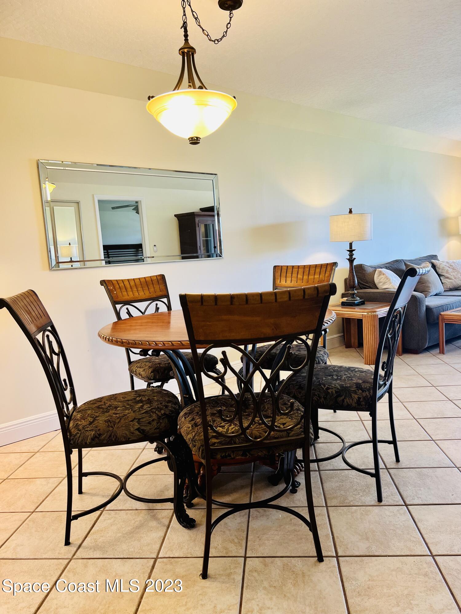416 School Road, Unit 204 Indian Harbour Beach, FL 32937 - Photo 9 of 14 a dining room with furniture and wooden floor