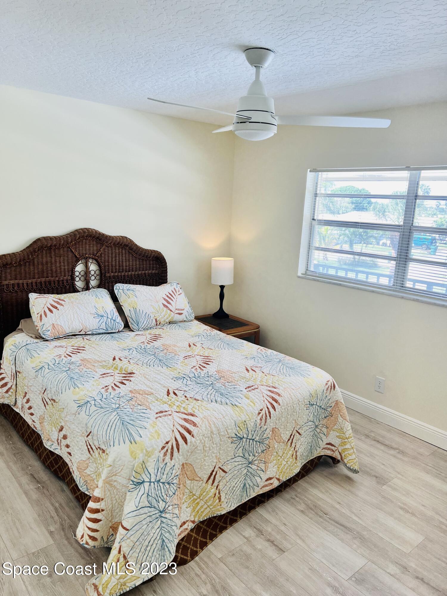 416 School Road, Unit 204 Indian Harbour Beach, FL 32937 - Photo 10 of 14 a bedroom with a bed and window