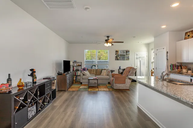 a living room with furniture and a wooden floor