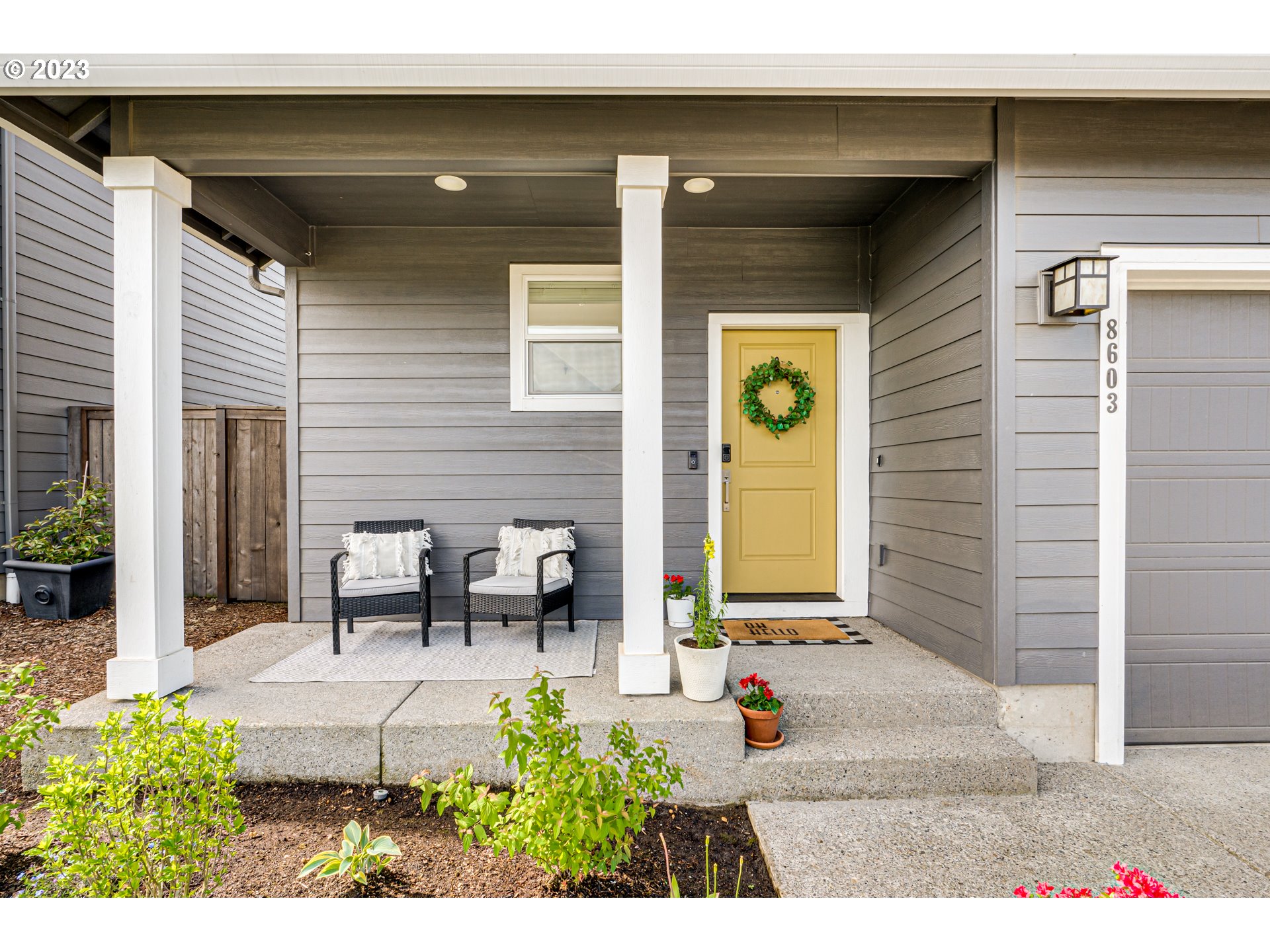 8603 North 1st Street Ridgefield, WA 98642 - Photo 3 of 33 a view of a patio with table and chairs and potted plants