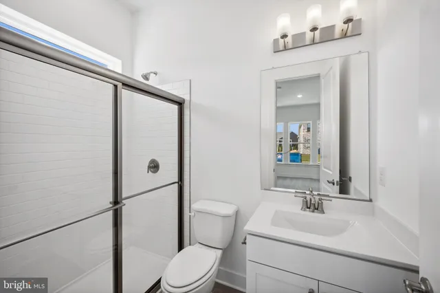 a bathroom with a toilet a sink and a mirror