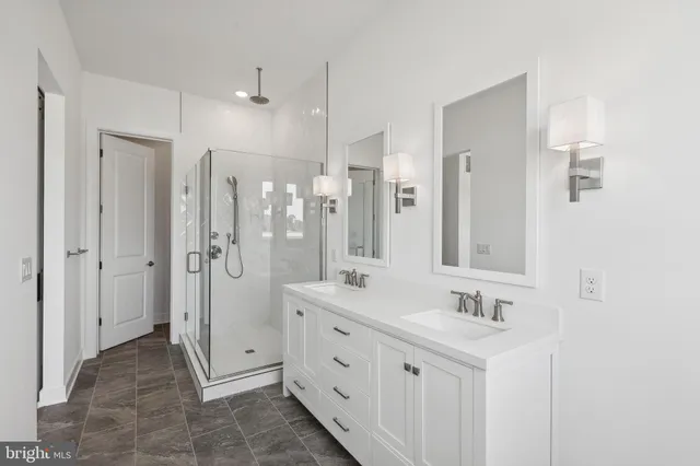 a bathroom with double sink and a mirror
