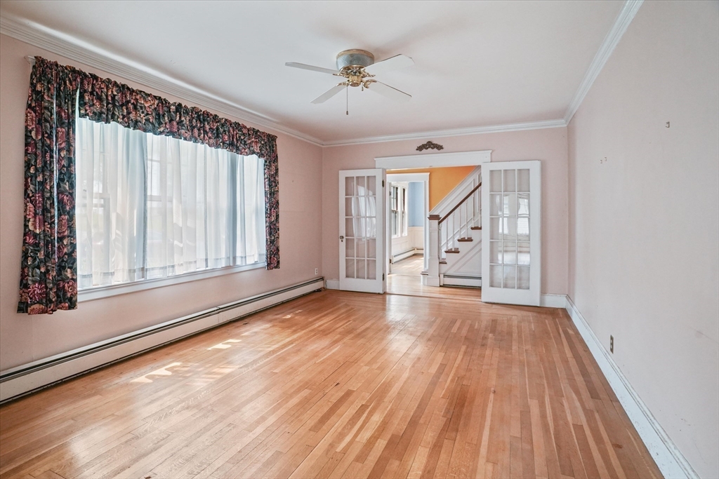 57 Olive Street Methuen, MA 01844 - Photo 11 of 38 a view of an empty room with wooden floor and a window