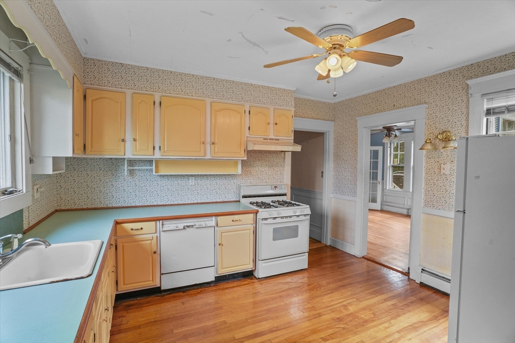 57 Olive Street Methuen, MA 01844 - Photo 3 of 38 a kitchen with stainless steel appliances granite countertop a stove a sink dishwasher and a refrigerator with wooden floor