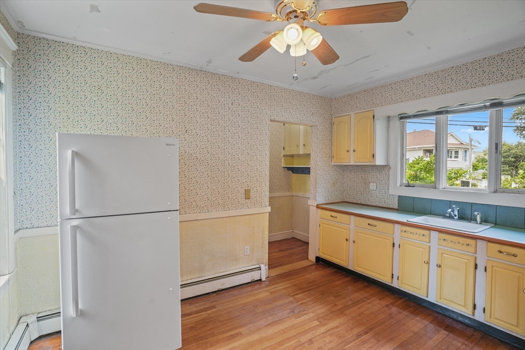 57 Olive Street Methuen, MA 01844 - Photo 5 of 38 a kitchen with a refrigerator and a sink