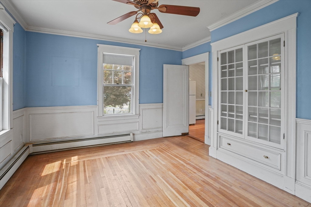 57 Olive Street Methuen, MA 01844 - Photo 6 of 38 a view of an empty room with a window and wooden floor