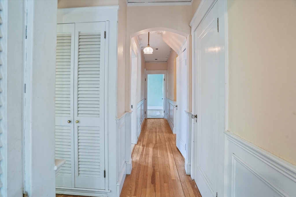 57 Olive Street Methuen, MA 01844 - Photo 8 of 38 a view of a hallway with wooden floor