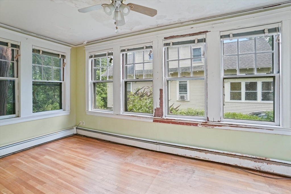 57 Olive Street Methuen, MA 01844 - Photo 9 of 38 an empty room with wooden floor and windows