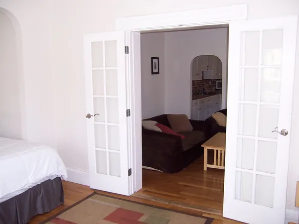 a bedroom with a bed and a rug