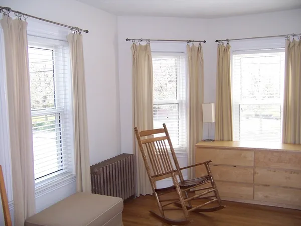 a view of a room with chair and windows