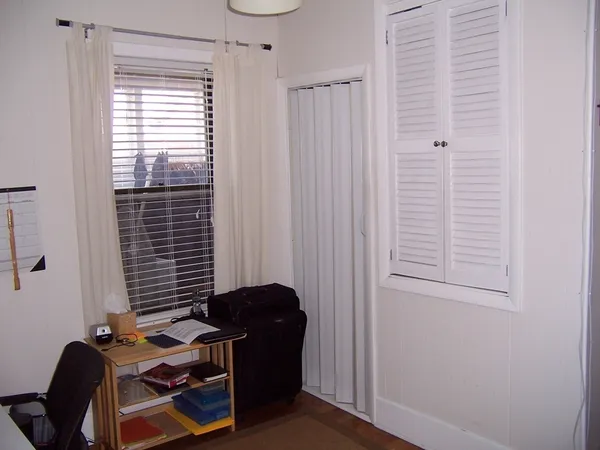 a view of a workspace with furniture and a window