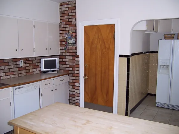 a kitchen with a refrigerator and cabinets
