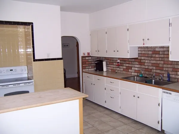 a kitchen with cabinets and white appliances