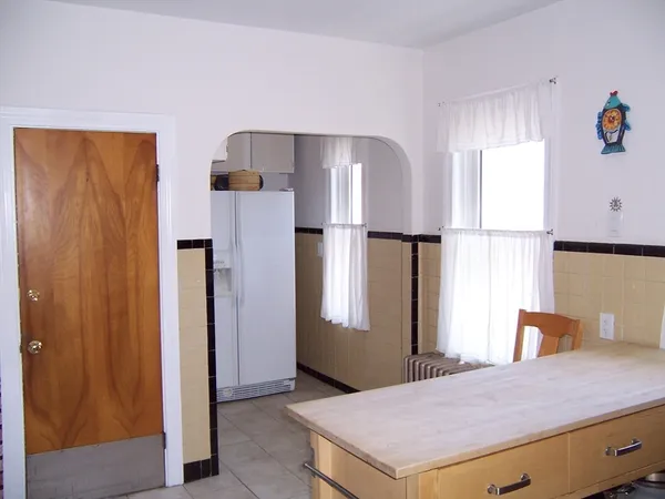 a kitchen with stainless steel appliances a refrigerator and a window