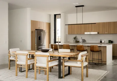 a living room with furniture and a painting on the wall