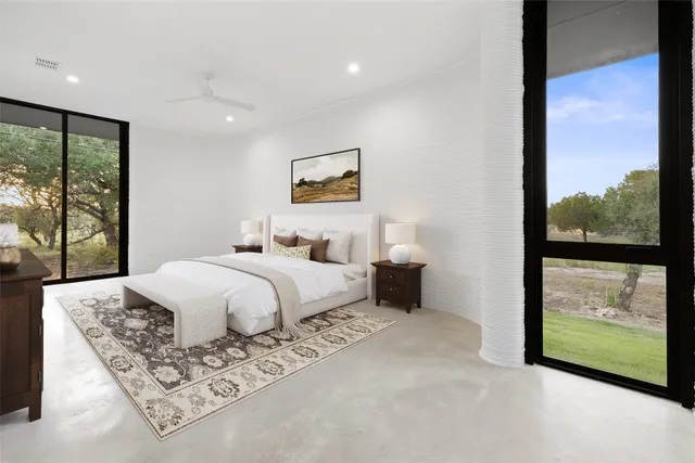 a bedroom with a large bed and a window