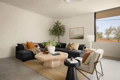 a spacious bedroom with a bed and glass windows