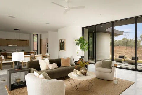 a living room with furniture and a lamp