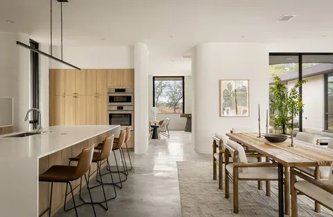 a living room with furniture and a large window with garden view