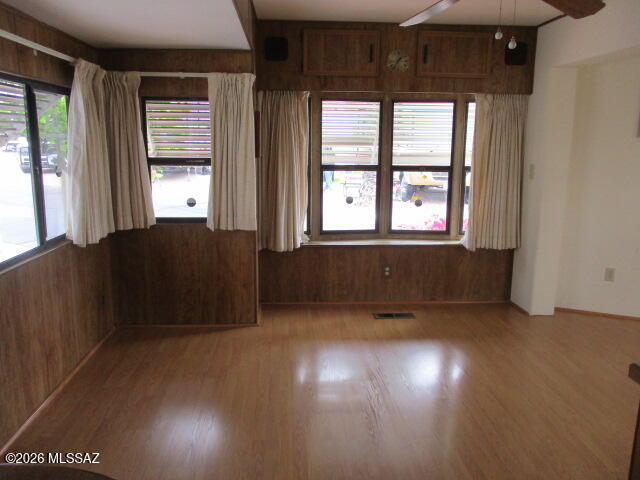 3100 South Kinney Road, Unit 193 Tucson, AZ 85713 - Photo 3 of 35 an empty room with wooden floor and windows