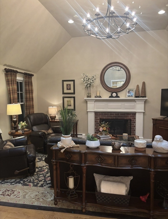 36 Bayberry Lane Hanover, MA 02339 - Photo 5 of 10 a living room with furniture a chandelier and a fireplace