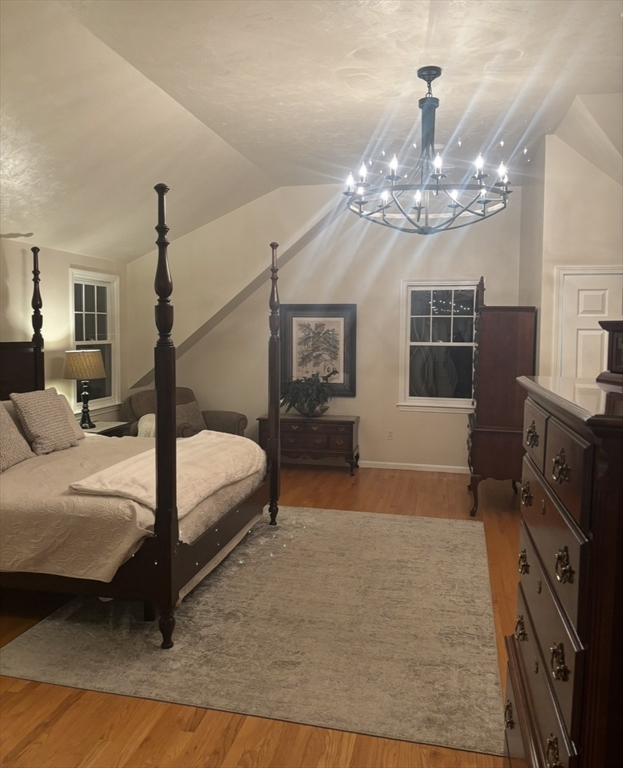 36 Bayberry Lane Hanover, MA 02339 - Photo 8 of 10 a spacious bedroom with a large bed and a chandelier