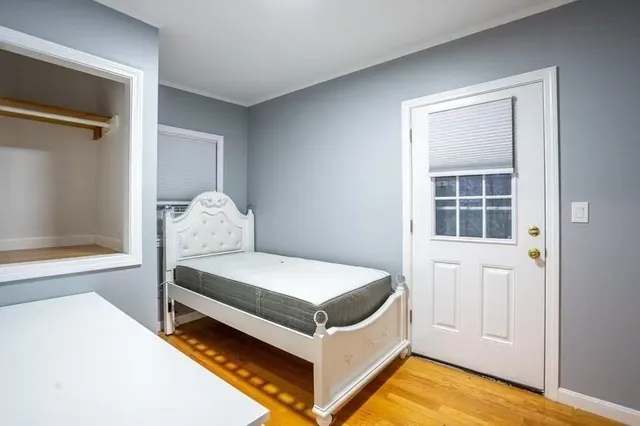 a bed room with a bed and a window