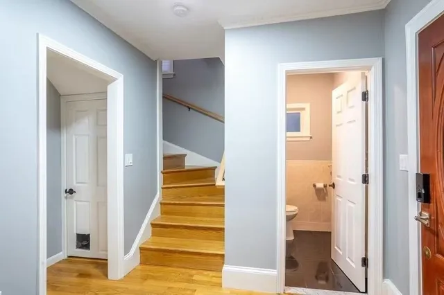 a view of a hallway with wooden floor and entryway