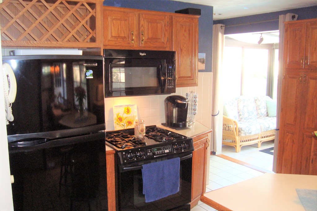 91 Brookside Road Rockland, MA 02370 - Photo 19 of 30 a kitchen with a stove and a wooden cabinets