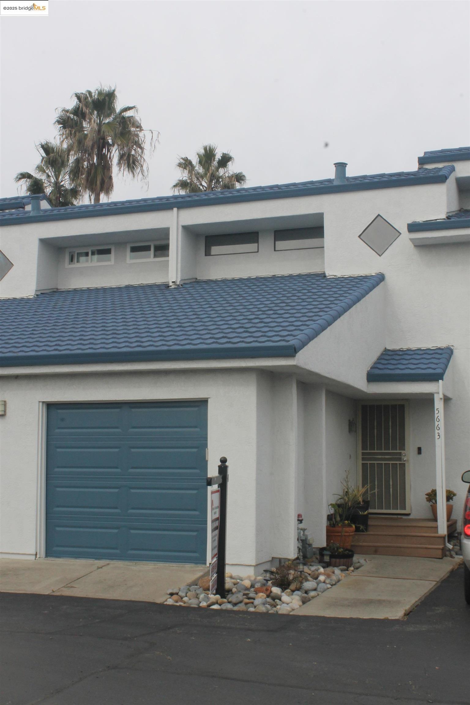 a front view of a house with garage