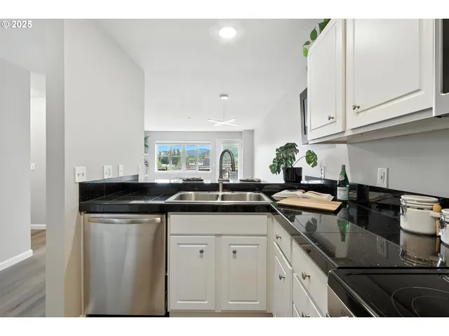 a kitchen with granite countertop a sink and cabinets