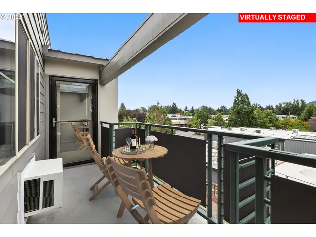 a balcony with table and chairs