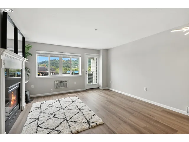 a living room with stainless steel appliances kitchen island a table and chairs