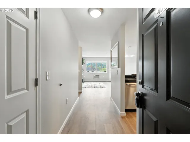 a view of hallway with wooden floor