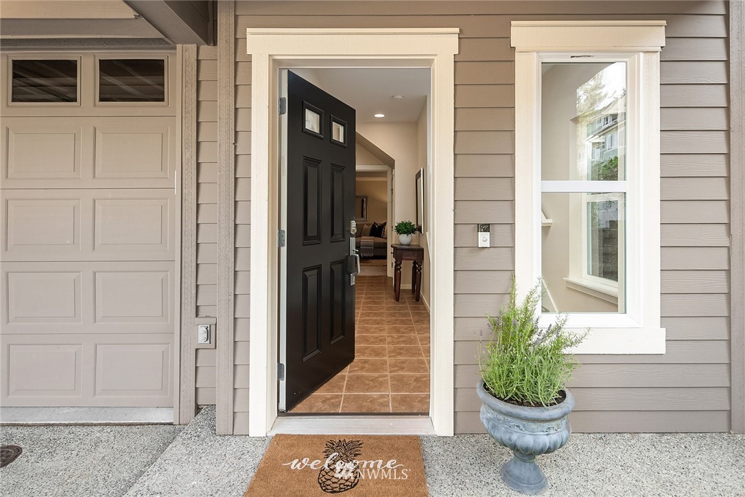 555 Alpine Ridge Place Northwest Issaquah, WA 98027 - Photo 2 of 31 a front view of a house with a potted plant
