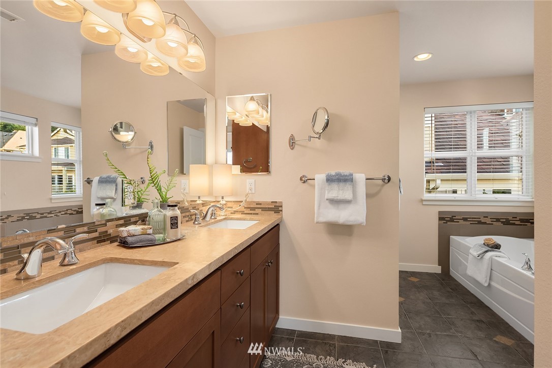 555 Alpine Ridge Place Northwest Issaquah, WA 98027 - Photo 24 of 31 a bathroom with a sink double vanity granite and a mirror