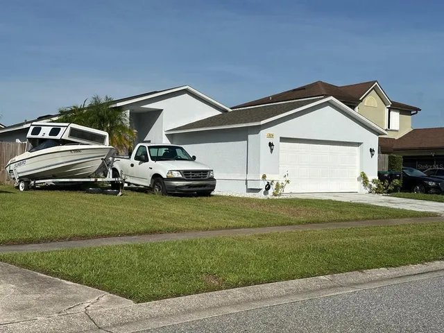 a front view of a house with a garden and yard